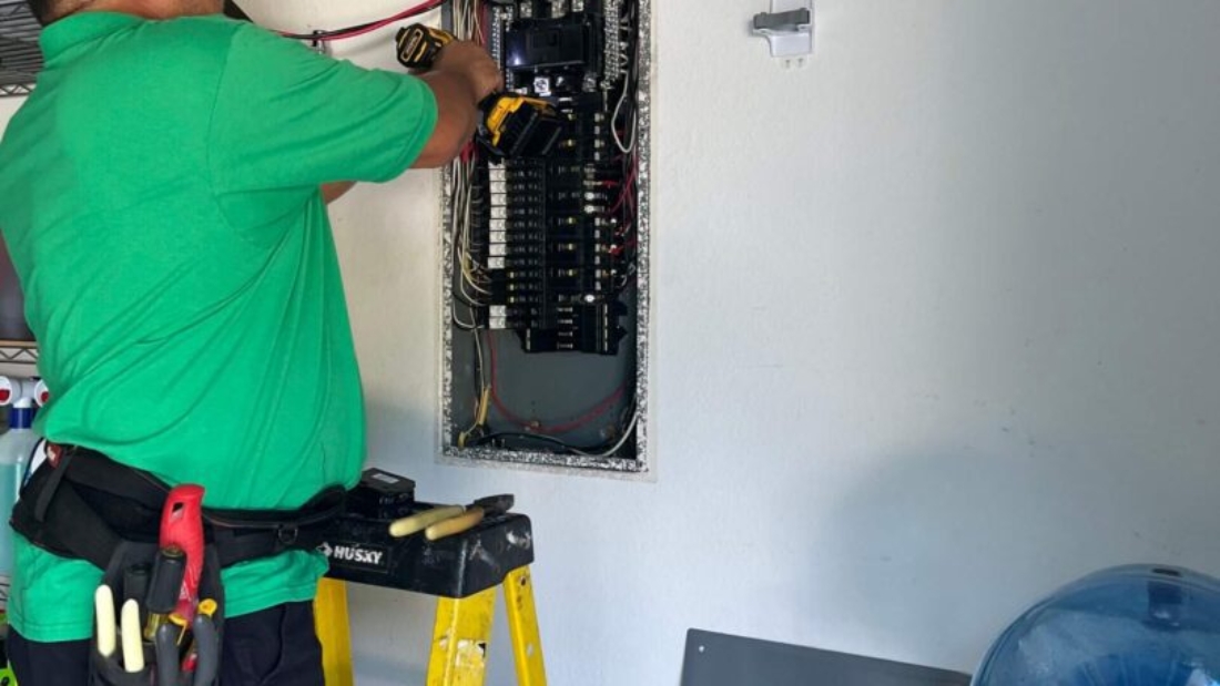 Electrician working on electrical panel.