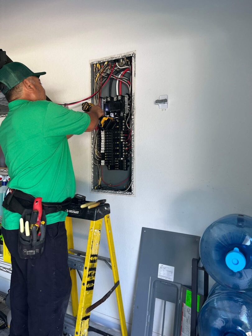 Electrician working on electrical panel.