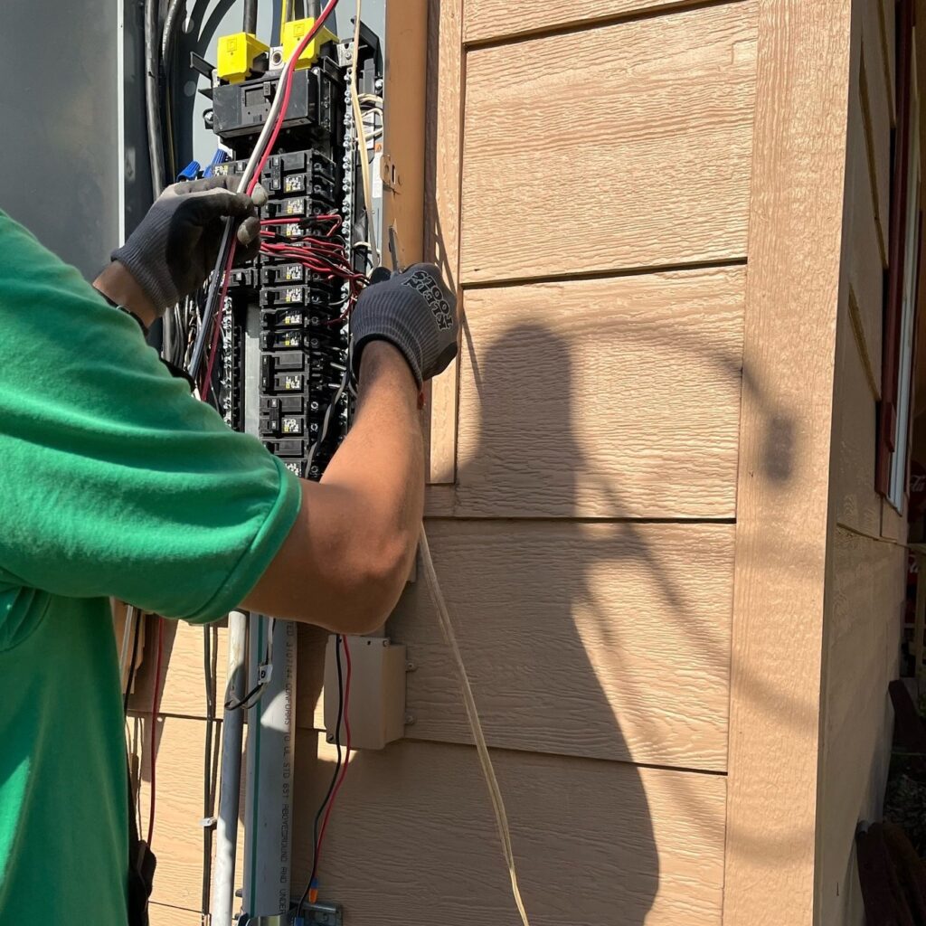 Electrician working on electrical panel.