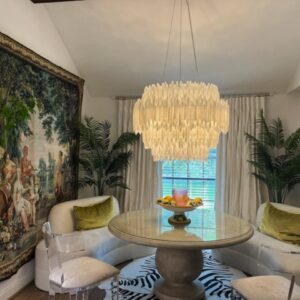 Crystal chandelier above dining room table.