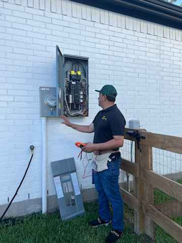 Electrician inspecting electrical panel outdoors.