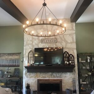 Large circular chandelier above fireplace.