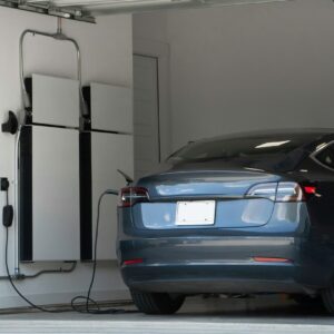 Tesla Model 3 charging in garage.