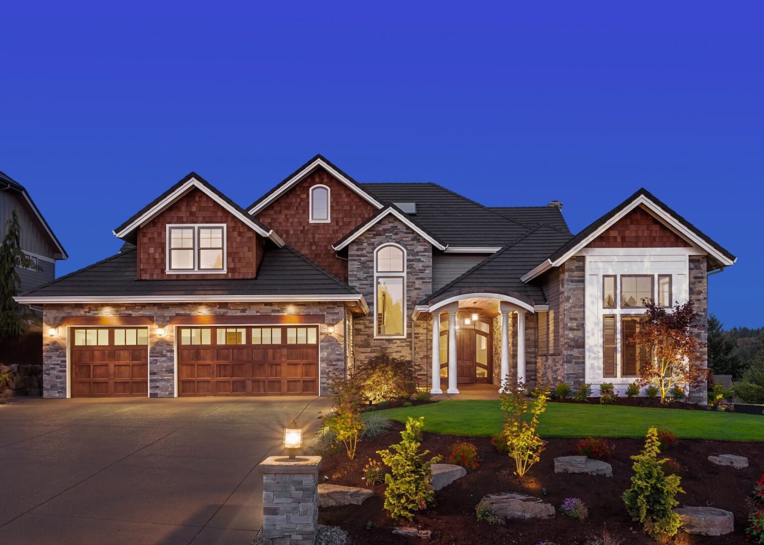 Luxury home exterior, nighttime view.