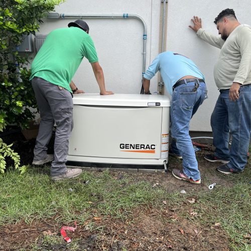 Three men installing Generac generator.